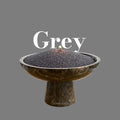 Lit candle burning in grey candle sand, unbound wax sold by weight